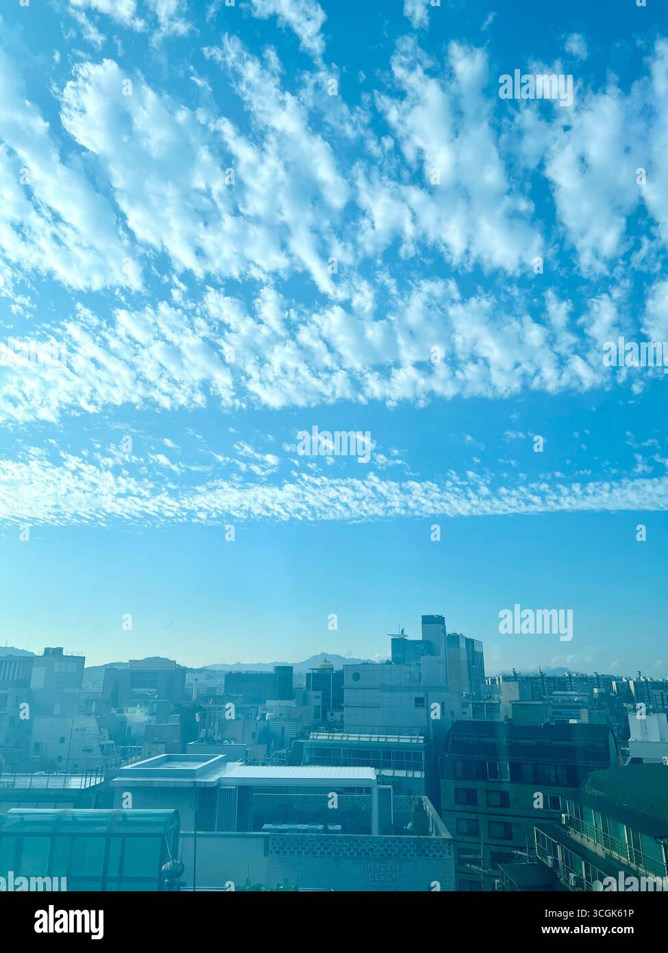 Sky view from the 6th floor in Gangnam, Seoul, with high clouds floating above the city buildings. - Smartphone Captured Stock Image