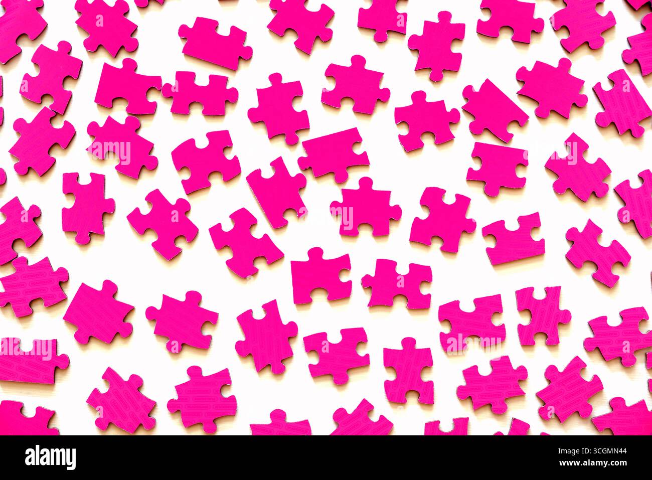 Different pink puzzle pieces on white table background Stock Photo
