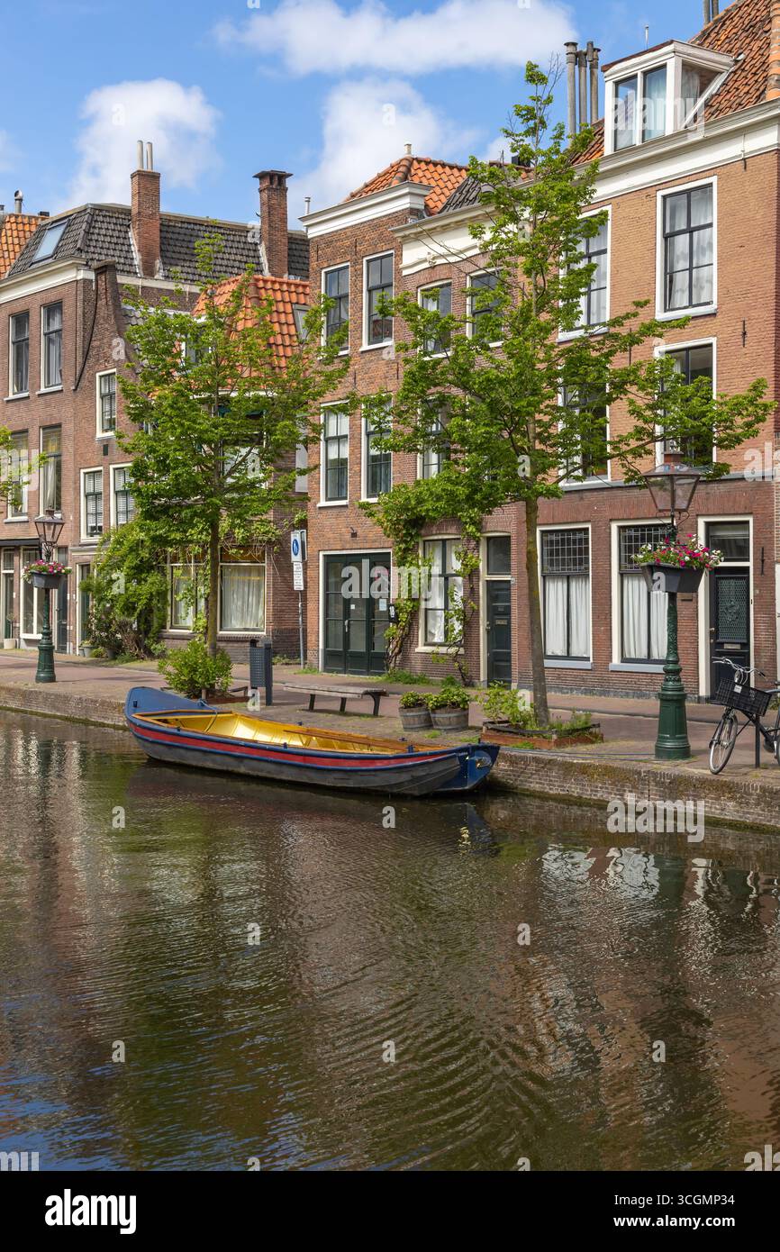 TREE LINED DUTCH CANAL IN AMSTERDAM HOLLAND AND AUTUMN COLOURED