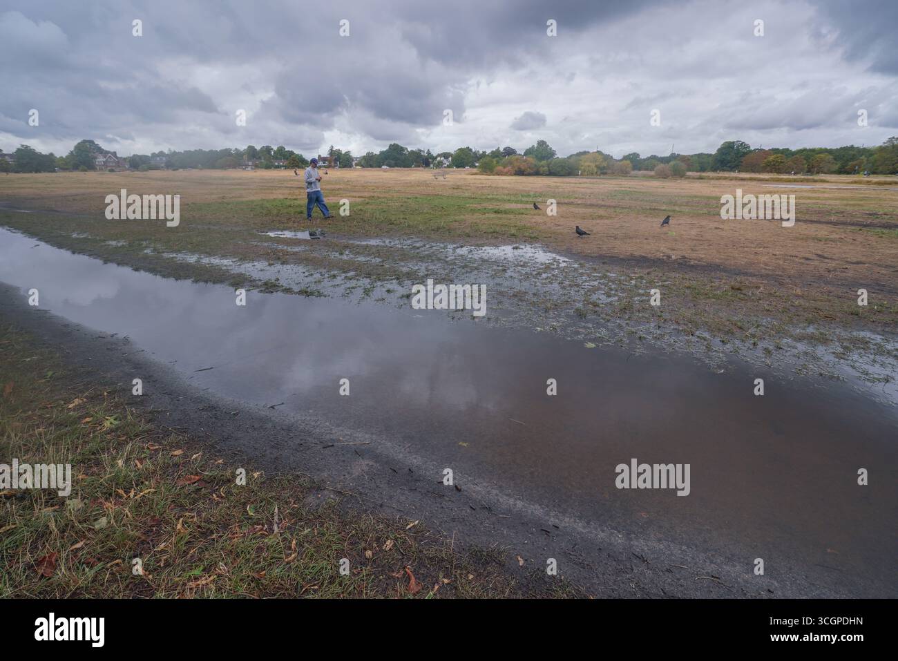 London, UK. 29 August 2025. A man walks past a flooded area on ...
