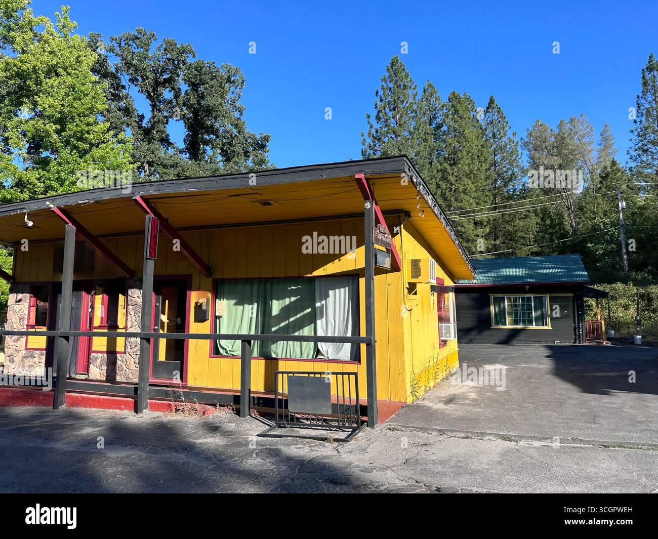Yellow roadside building with red trim and Open sign - Smartphone Captured Stock Image