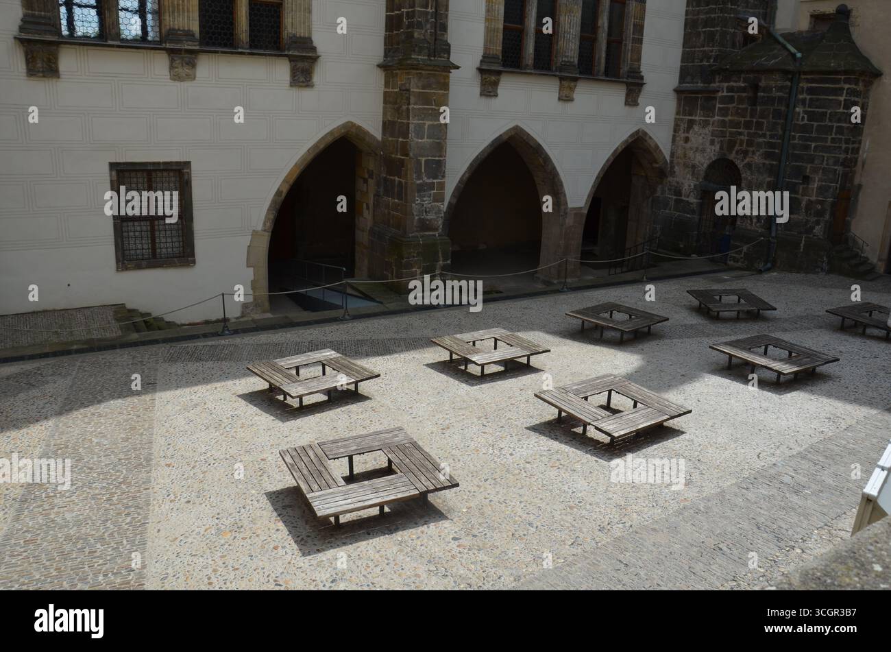 Square Wooden Benches on Castle Courtyard Stock Photo