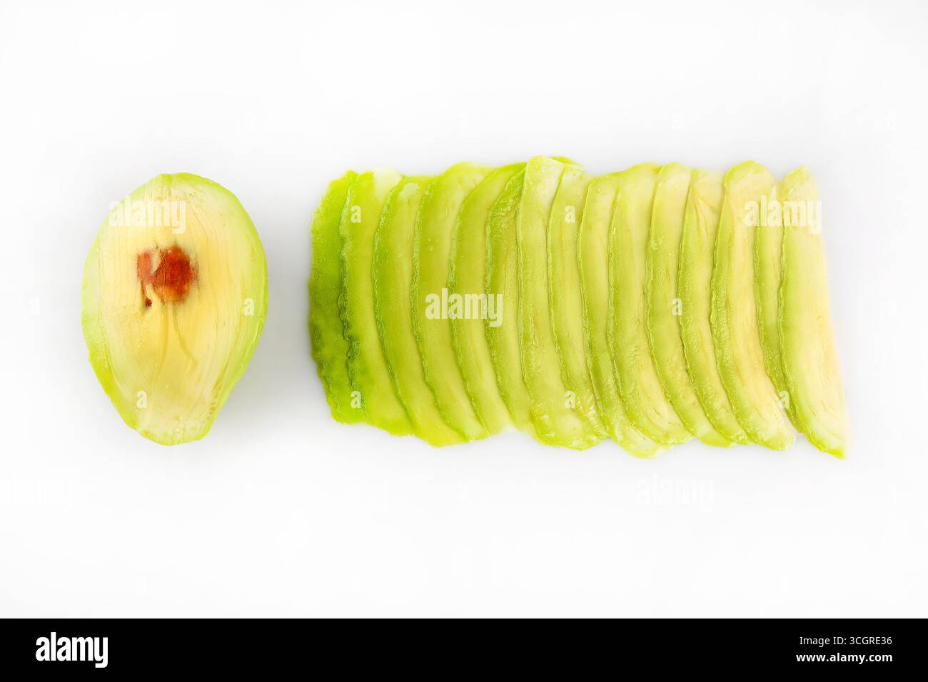 Falling avocado slices isolated on white background Stock Photo