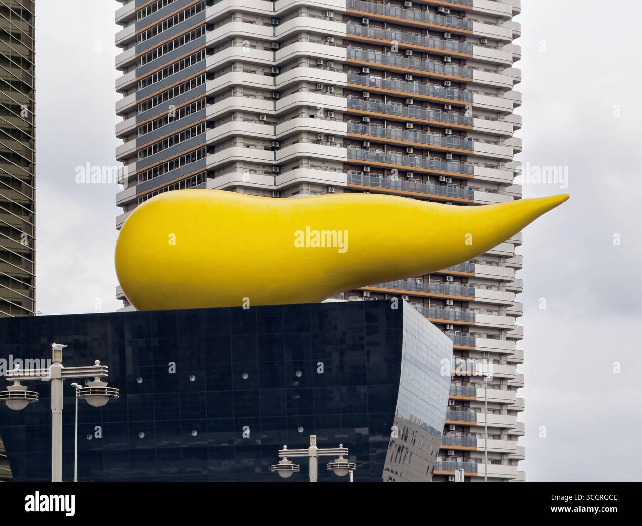 Asahi Breweries in Sumida, Tokyo, Japan. Asahi Beer Hall with Asahi Flame on the east bank of the Sumida River. - Smartphone Captured Stock Image
