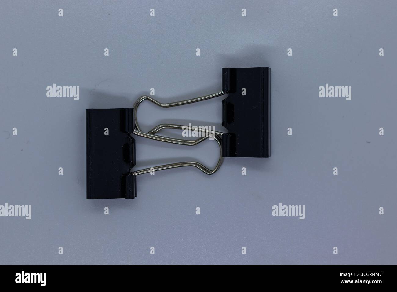 Small Office Binder Clips Isolated on Plain White Background Stock Photo