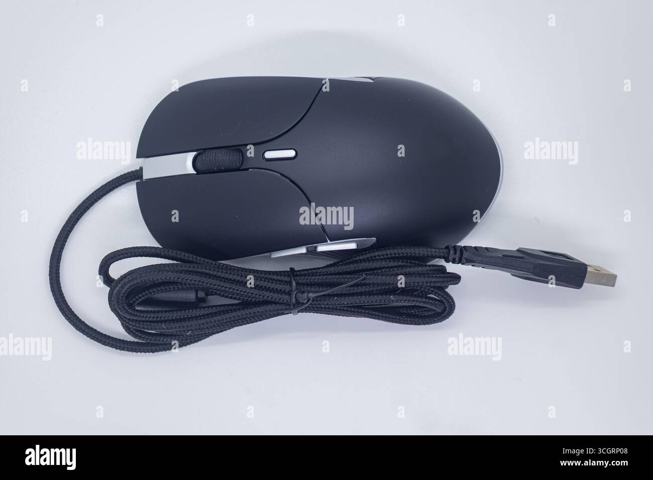 Standard Black Wired Computer Mouse with Silver Trim on Clean White Background Stock Photo