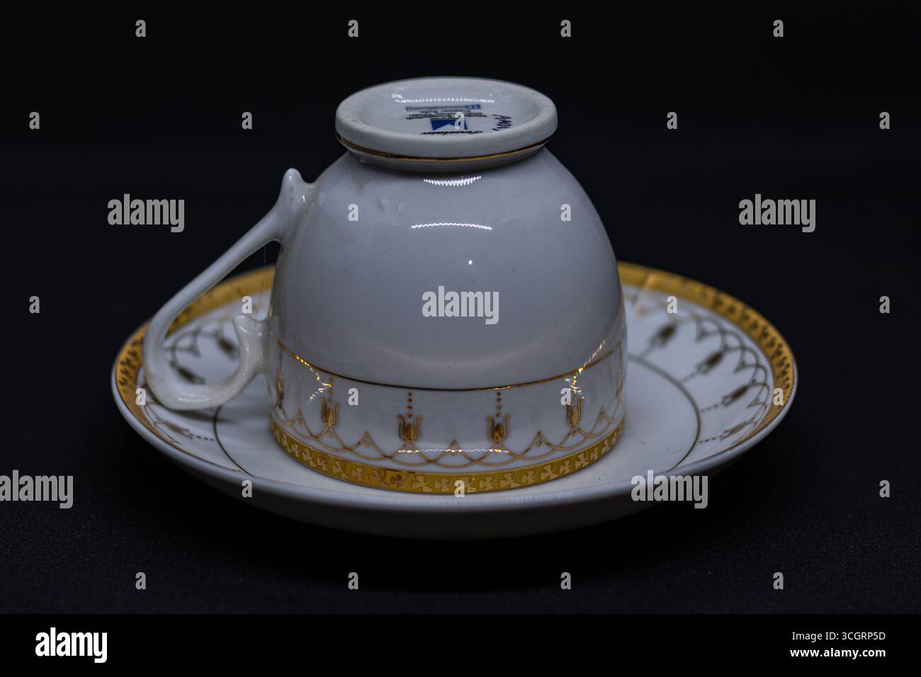 The cup is designed with a delicate handle, perfect for holding hot beverages such as tea or coffee Stock Photo