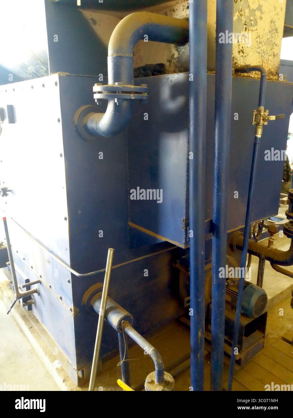 A large blue water boiler is positioned in a utility area equipped with ...