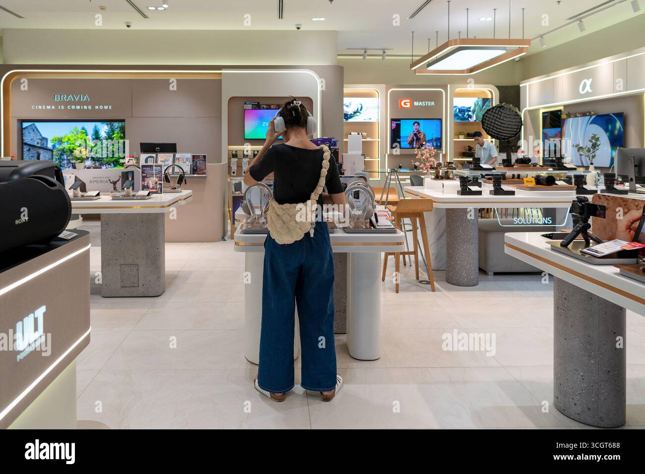 Sony Rama Studio Bangkok, Thailand - October 13, 2024: a woman trying on wireless noise ...