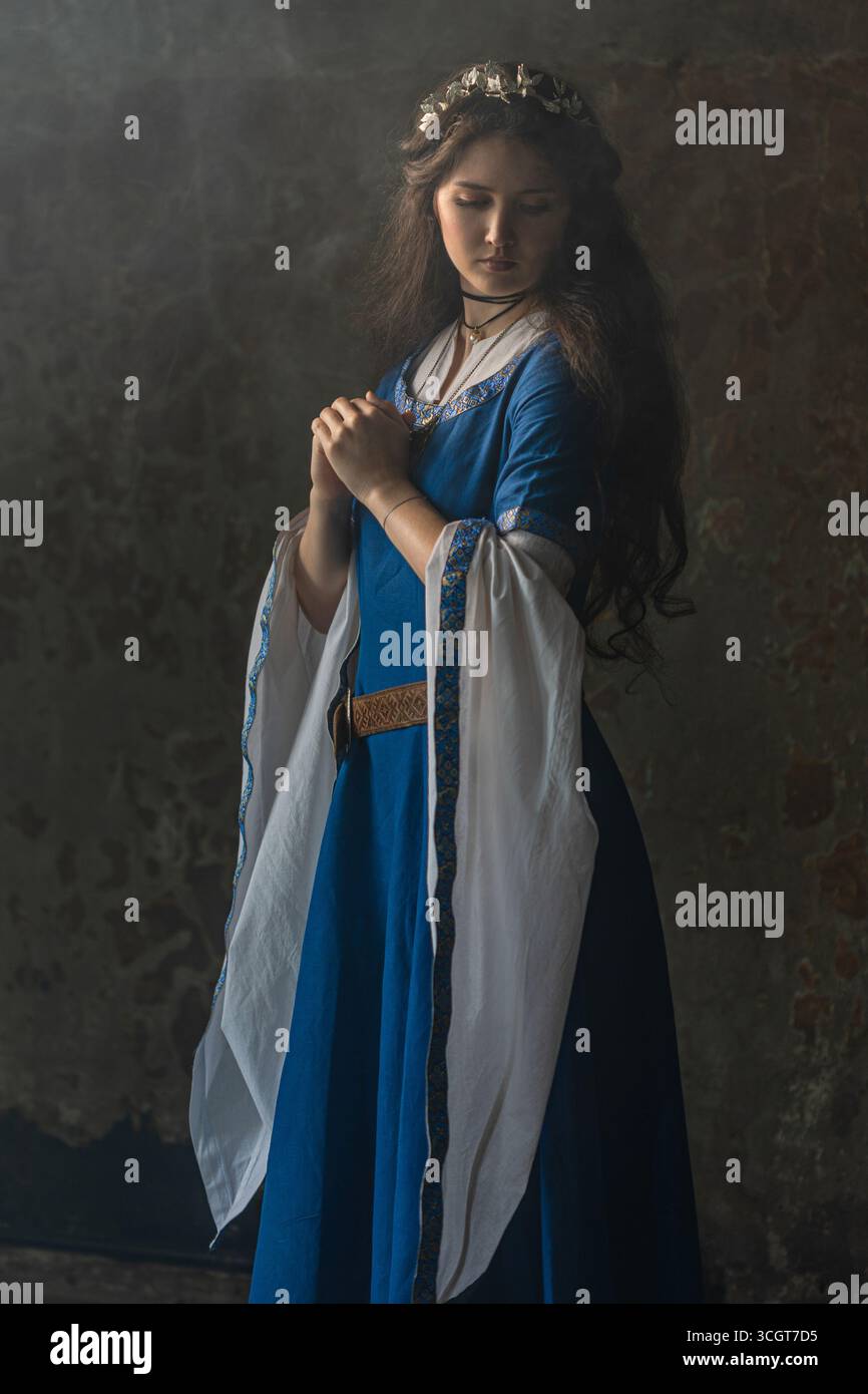 Regal fantasy woman in blue medieval robe, historical character ...