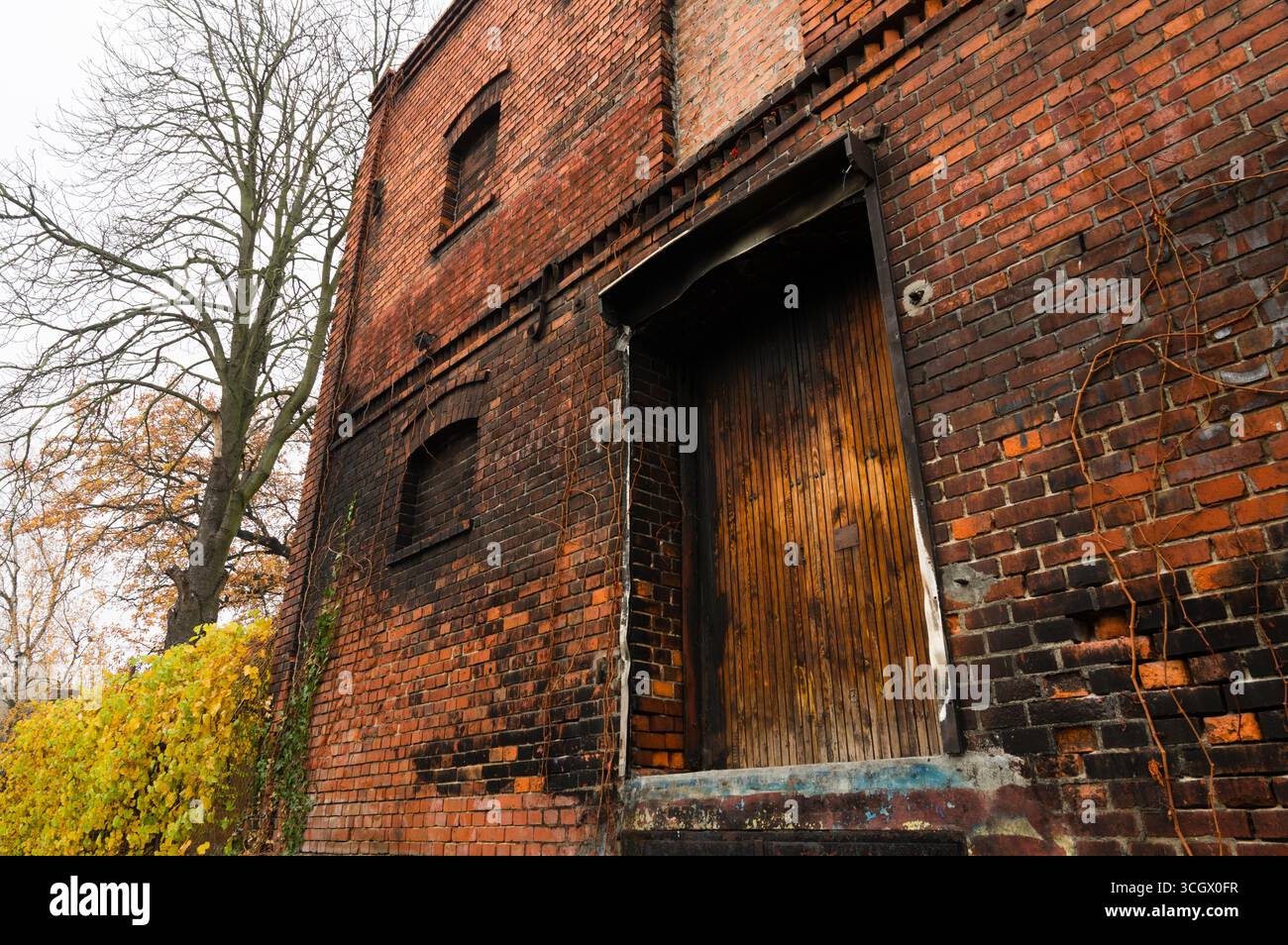 Abandoned brick house burned and damaged by fire. Stock Photo
