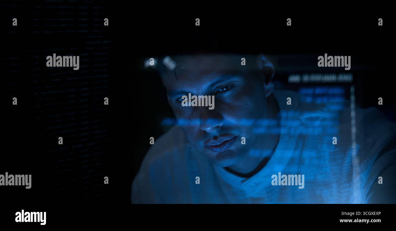 Programmers and coding. Programmer or Developer working in dark room with computer code reflected on their monitor. Cybersecurity software development Stock Photo