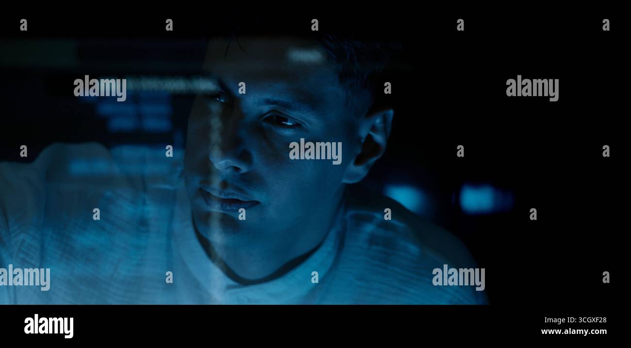 Programmers and coding. Programmer or Developer working in dark room with computer code reflected on their monitor. Cybersecurity software development Stock Photo