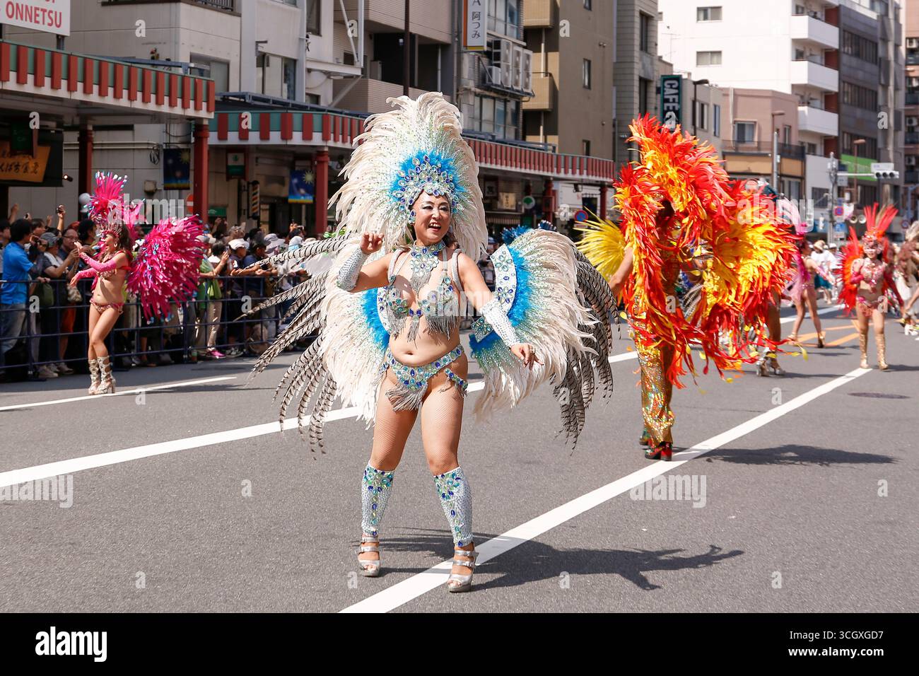 Samba dancers perform through the streets of the traditional Asakusa ...
