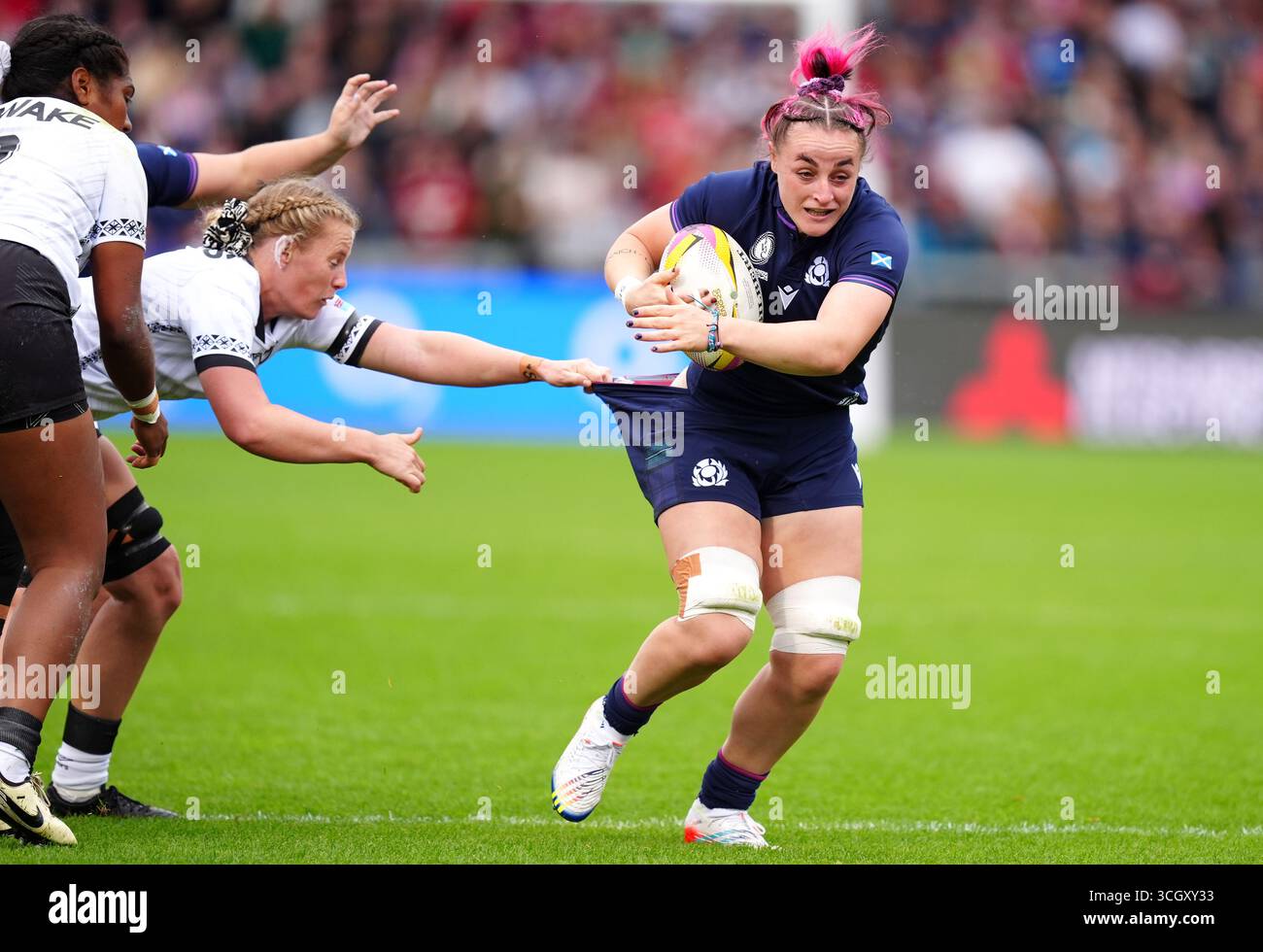 Jade Ruaa Rugby Scotland's Evie Gallagher (right) is grabbed by Fiji's Jade Coates ...