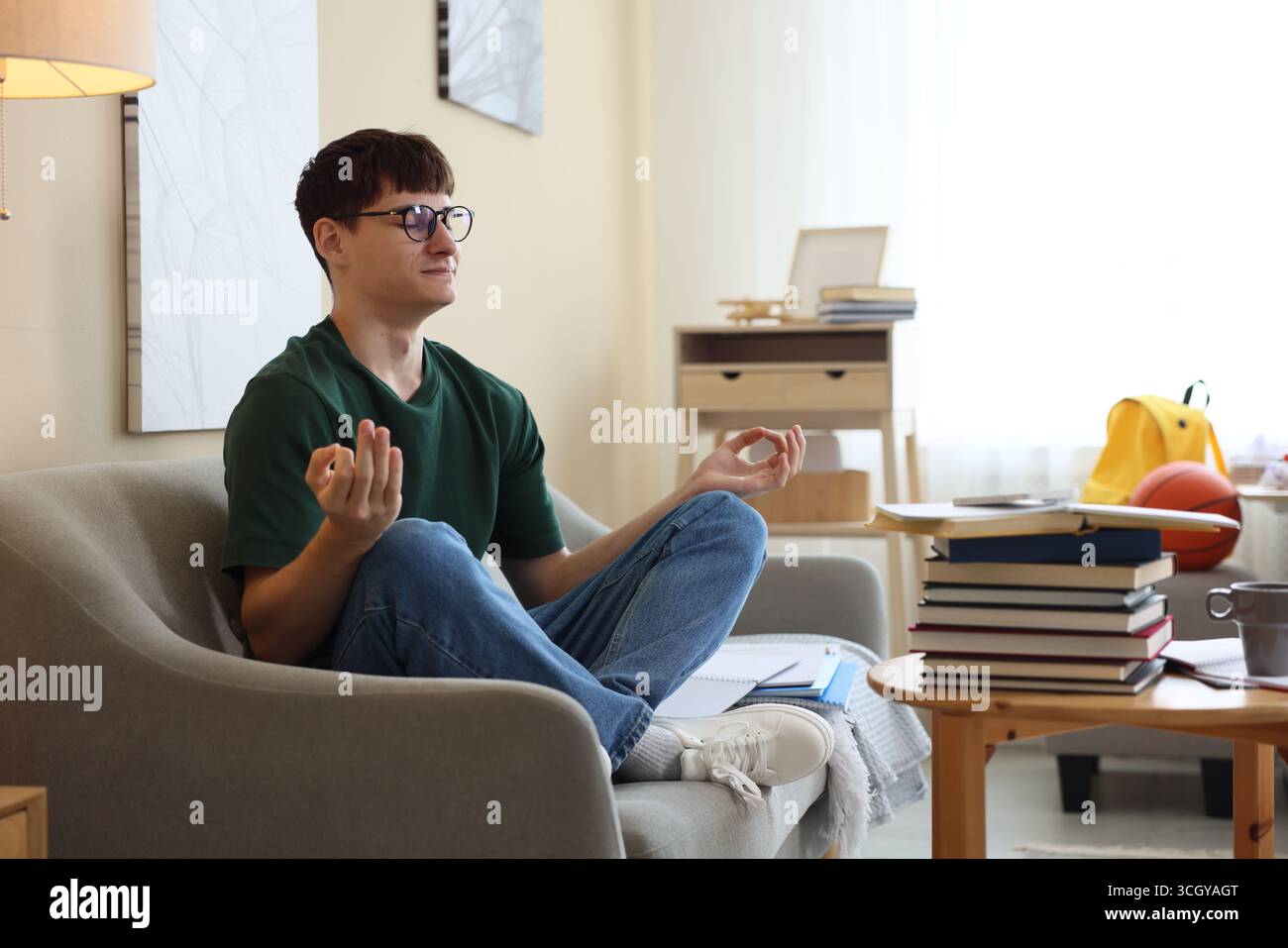 Student preparing for exam and meditating at home Stock Photo