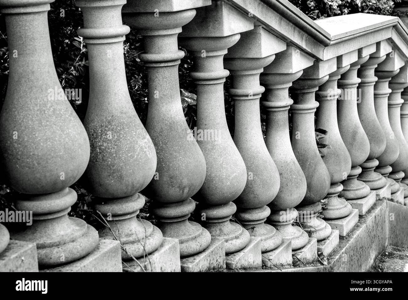 A black and white image of a ballustrade with stone balusters (pillars) on a set of garden steps Stock Photo