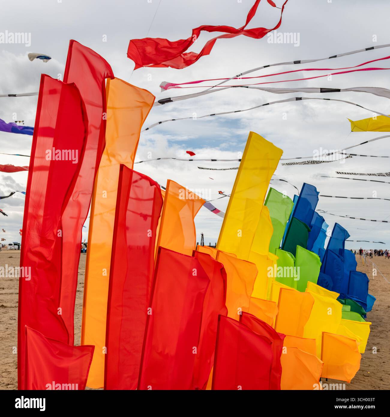 Vibrant flags in a rainbow of colors fly in the wind, symbolizing ...