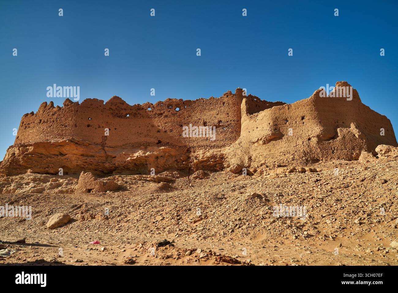 Ancient mud-brick fortress ruins in the Algerian Sahara desert under ...