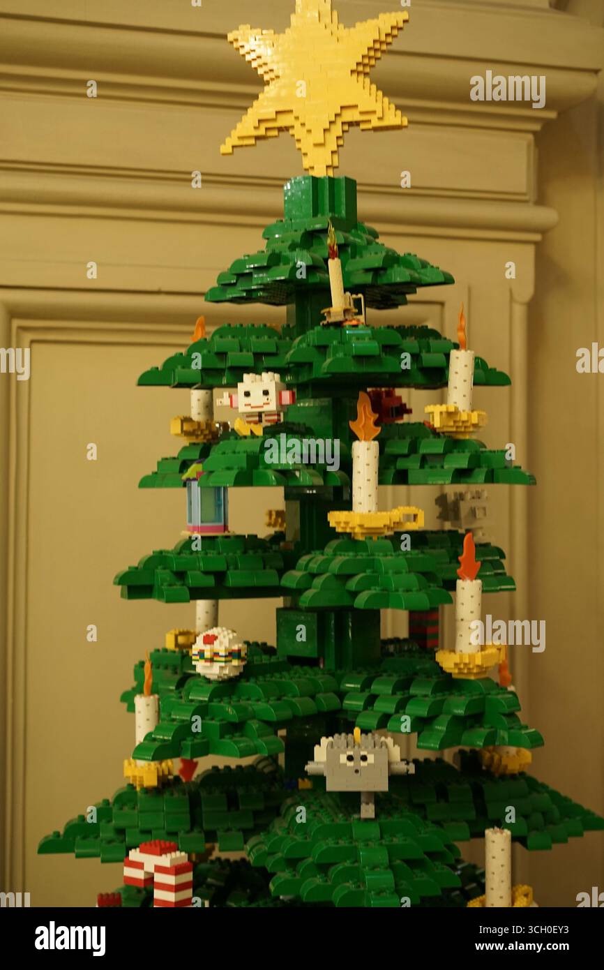 A festive Christmas tree crafted from colorful pixel-style bricks ...