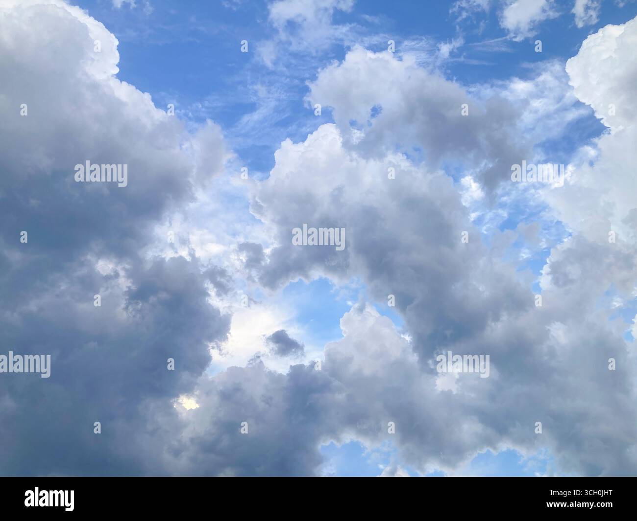 Beautiful white puffy clouds in blue sky Stock Photo