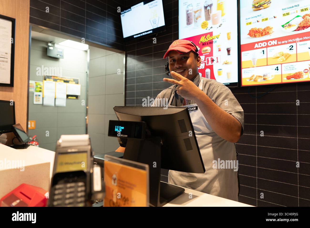 Kuala Lumpur, Malaysia - September 17, 2024: a man working as a cashier ...