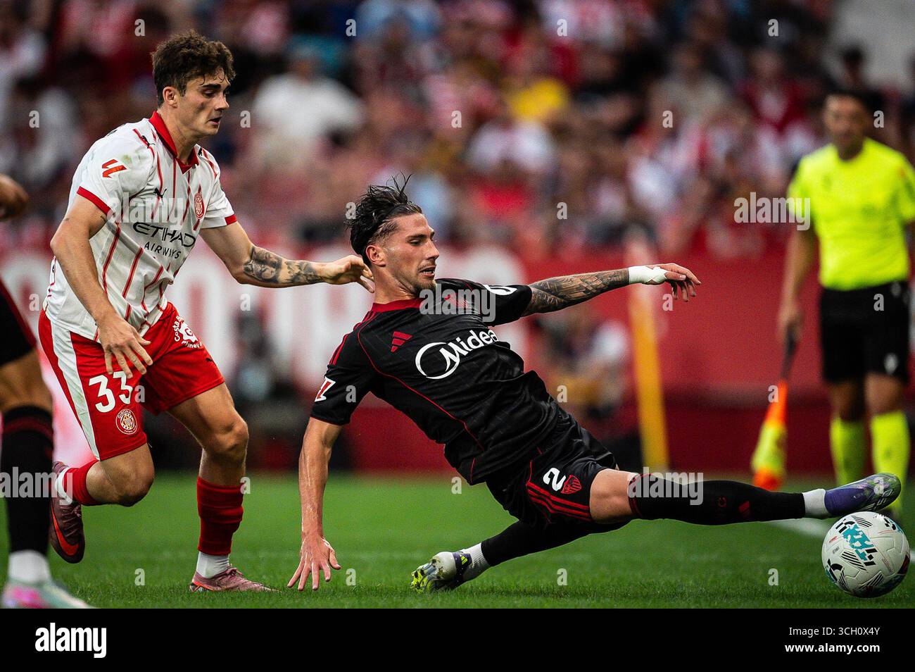 Joel ROCA of Girona and Jose Angel CARMONA of Sevilla FC during the ...