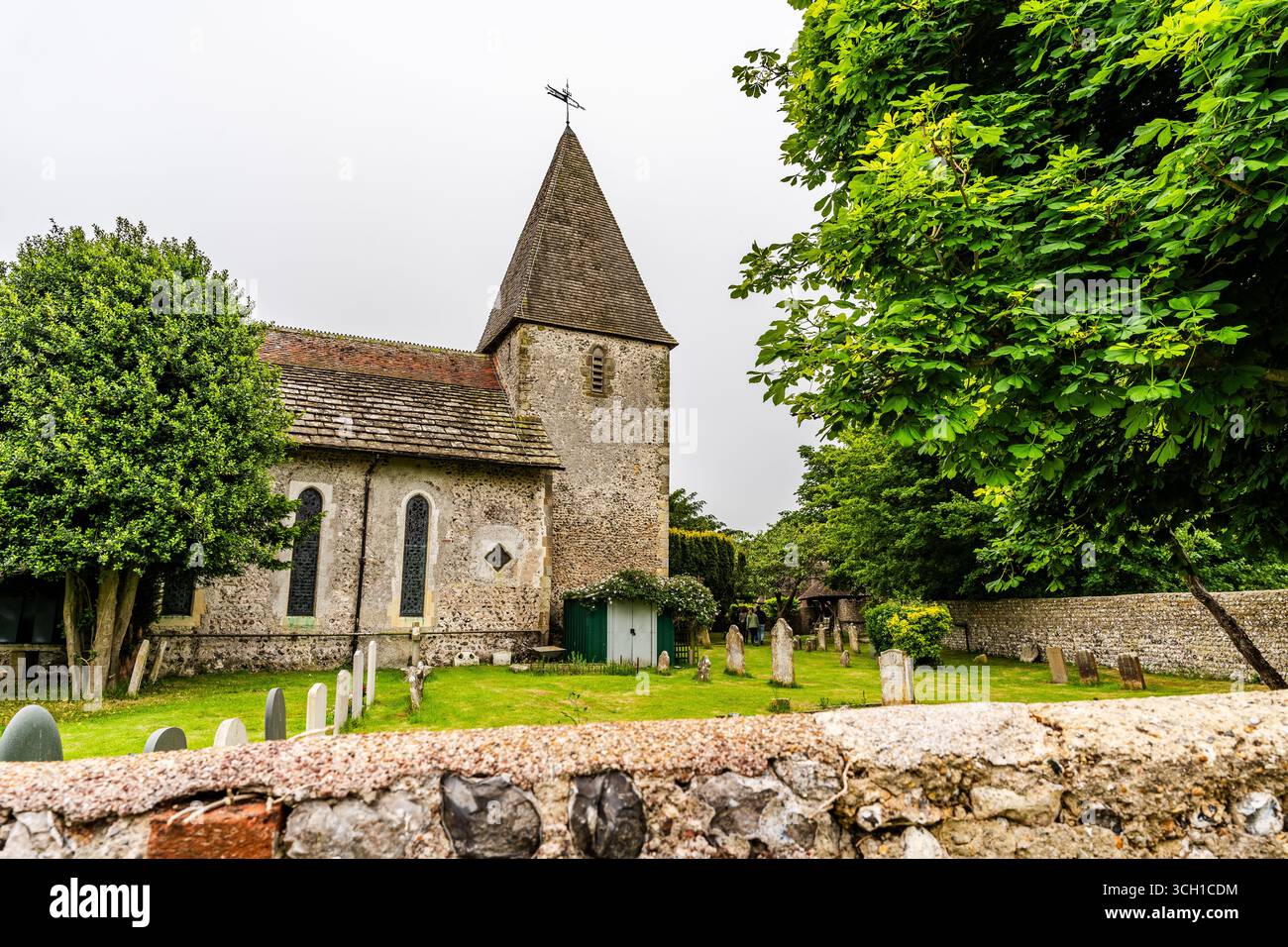 St Peter's Church and graveyard, historic Norman architecture near Monk's House where writer Virginia Woolf lived, in East Sussex, United Kingdom. Stock Photo