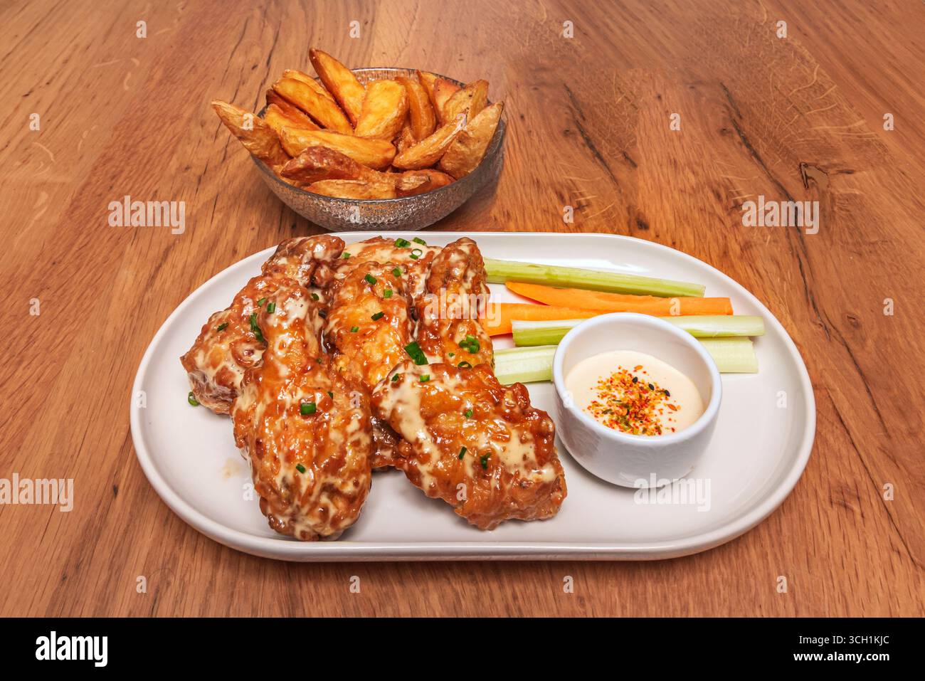 Wings smothered in spicy salsa verde, prepared with tomatillos, cilantro, and fresh serrano peppers Stock Photo