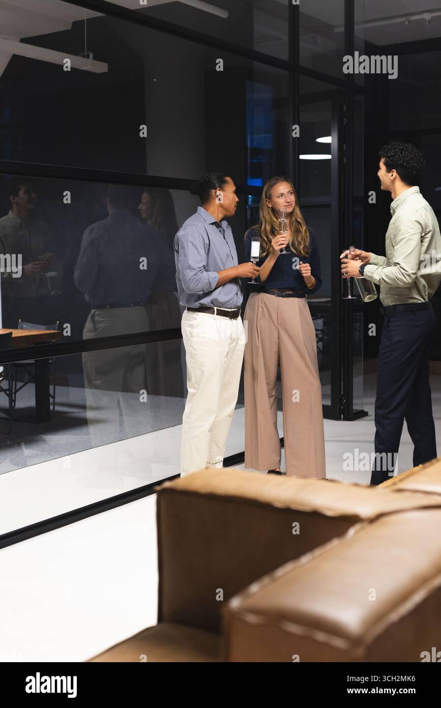 In office, diverse colleagues having drinks and conversation during evening gathering, copy space Stock Photo