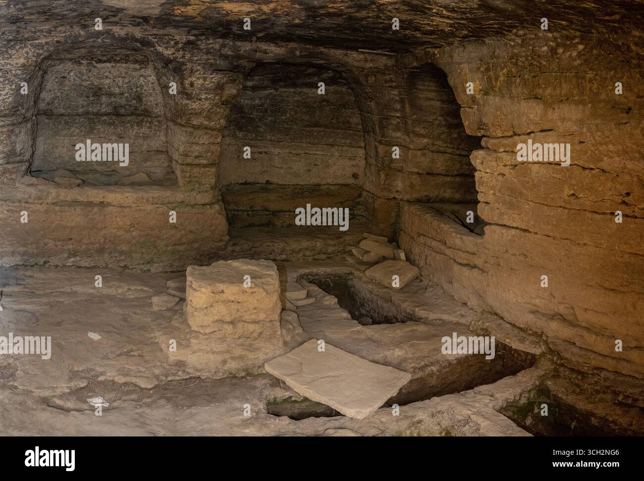 Ancient stone cave with carved walls and scattered rocks from the Roman ...