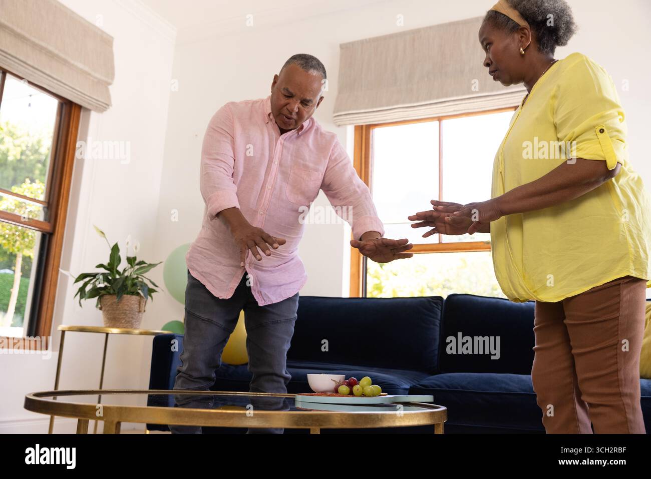 Dancing together at home, senior couple sharing joyful moment Stock Photo
