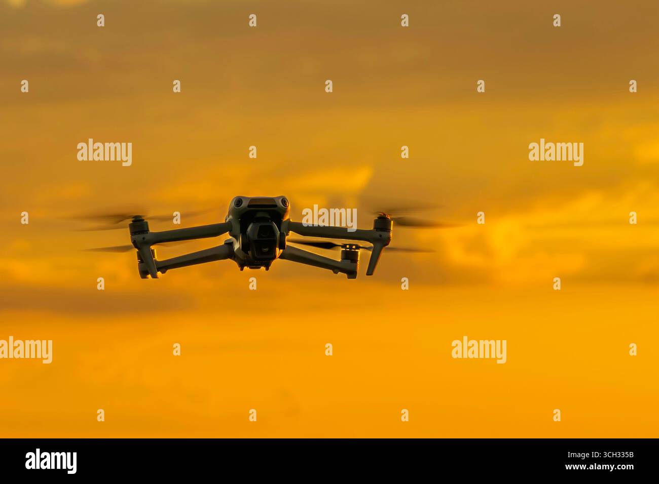 A drone in the sky at sunset Stock Photo