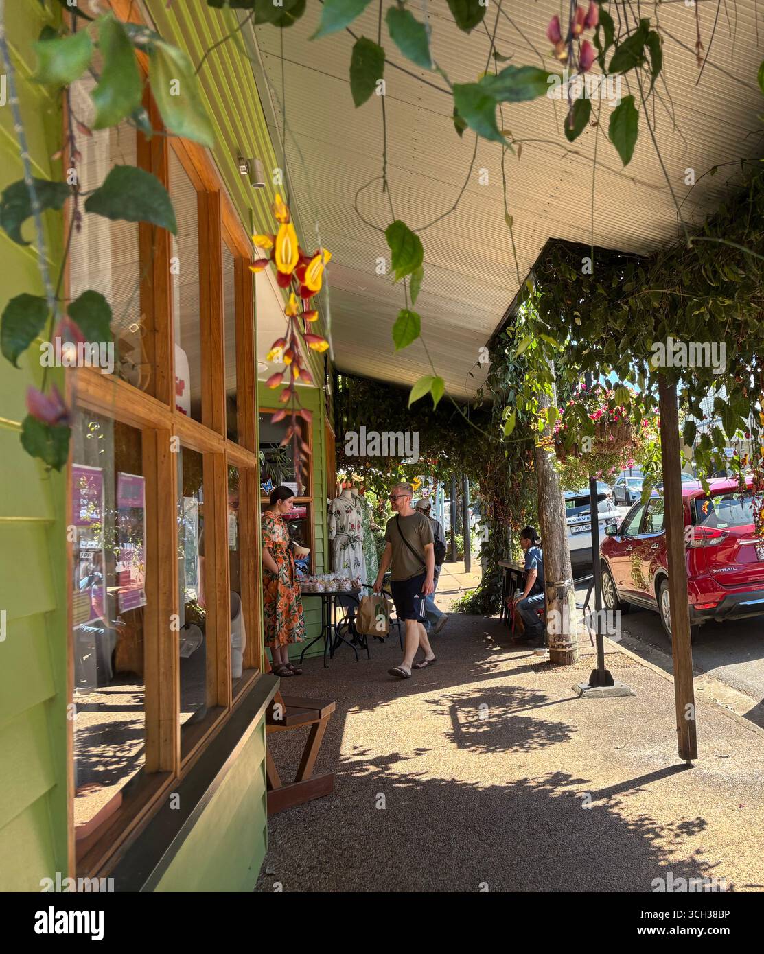 Man shopping in cool heritage buildings, Winter & Mann boutique, Yungaburra, Atherton Tablelands, near Cairns, Queensland, Australia. No MR or PR - Smartphone Captured Stock Image