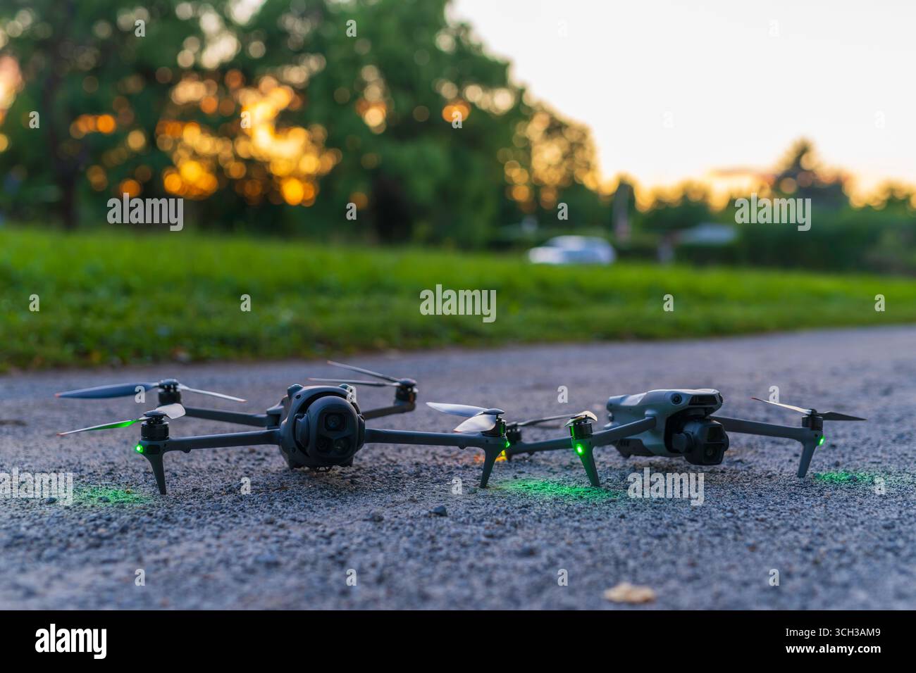 Two drones on the ground at sunset Stock Photo