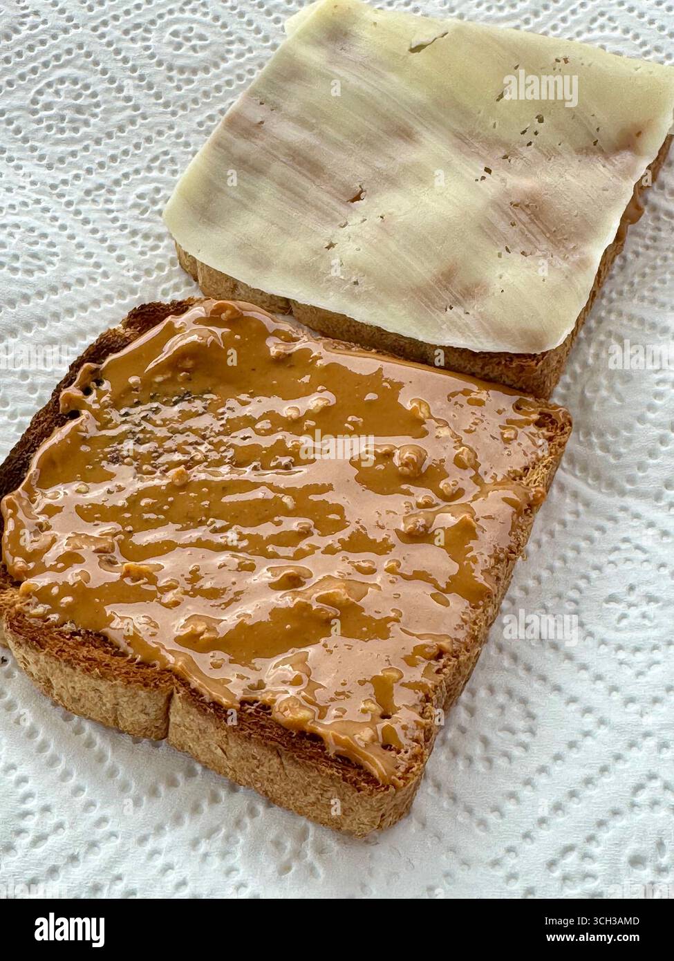 Peanut butter protein toast with slice of cheese on wholegrain bread. - Smartphone Captured Stock Image