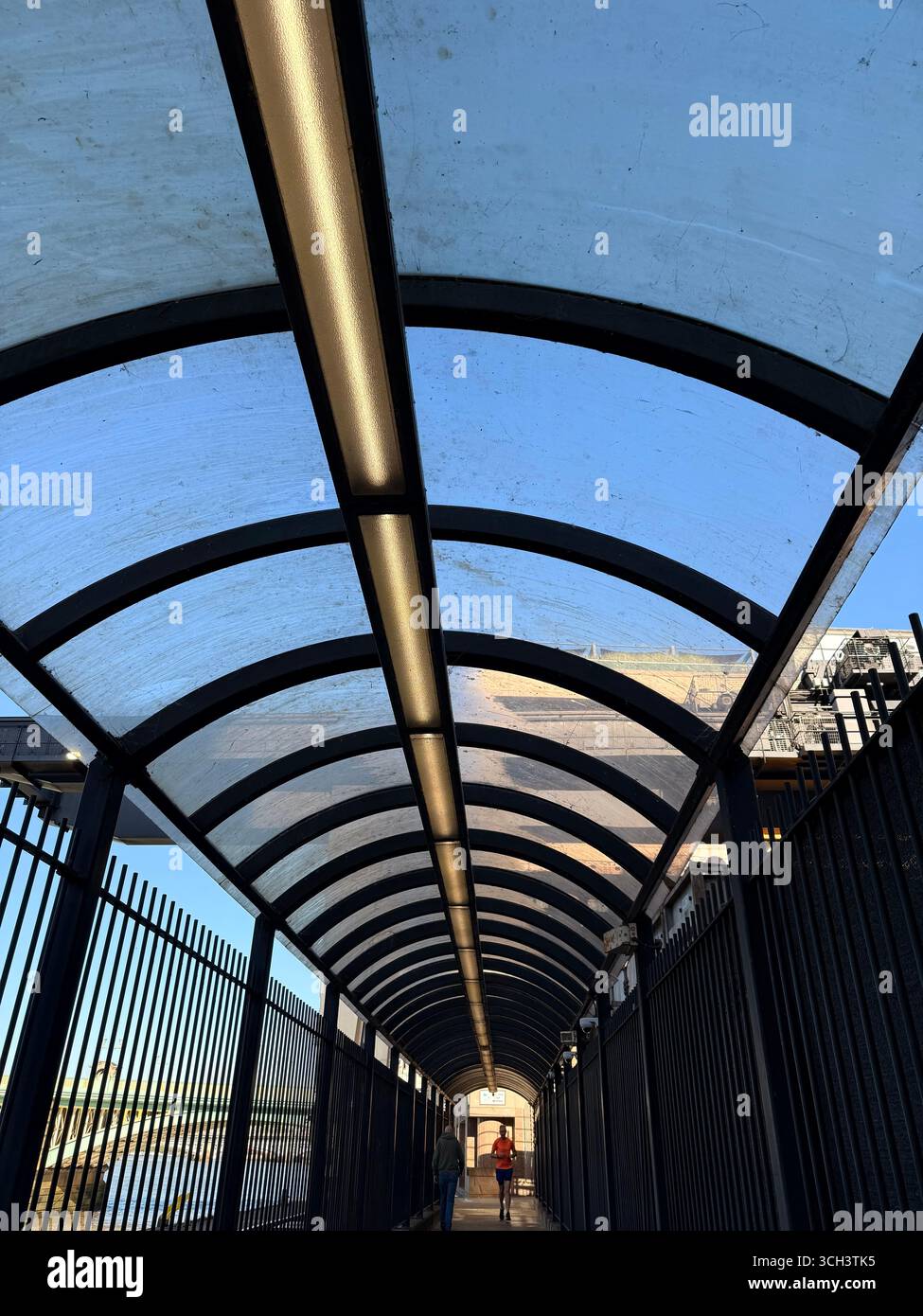Covered pedestrian bridge an runner at Walbrook whalf, Vintry in London - Smartphone Captured Stock Image