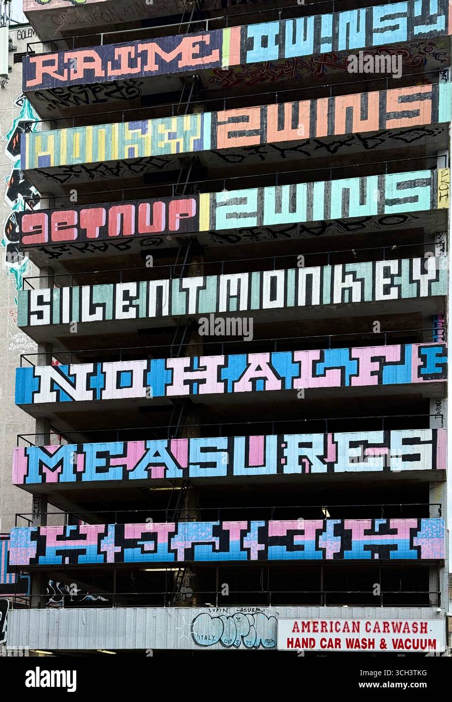 Graffiti on derelict multi story car park (now a car wash) in Shoreditch, London - Smartphone Captured Stock Image