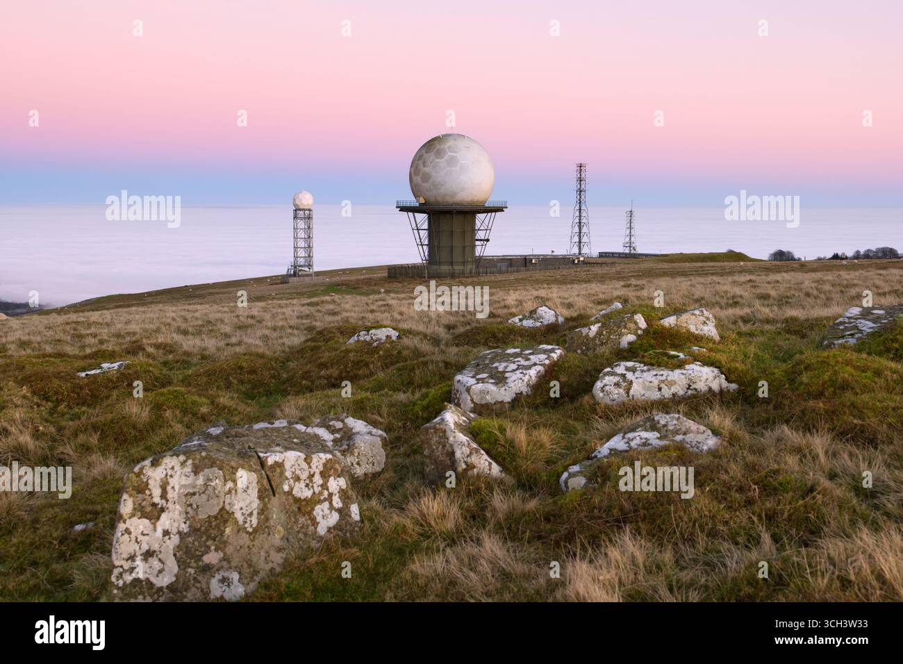 Shropshire's Titterstone Clee Hill summit, with NATS air traffic & Met Office weather radar domes above a cloud inversion Stock Photo