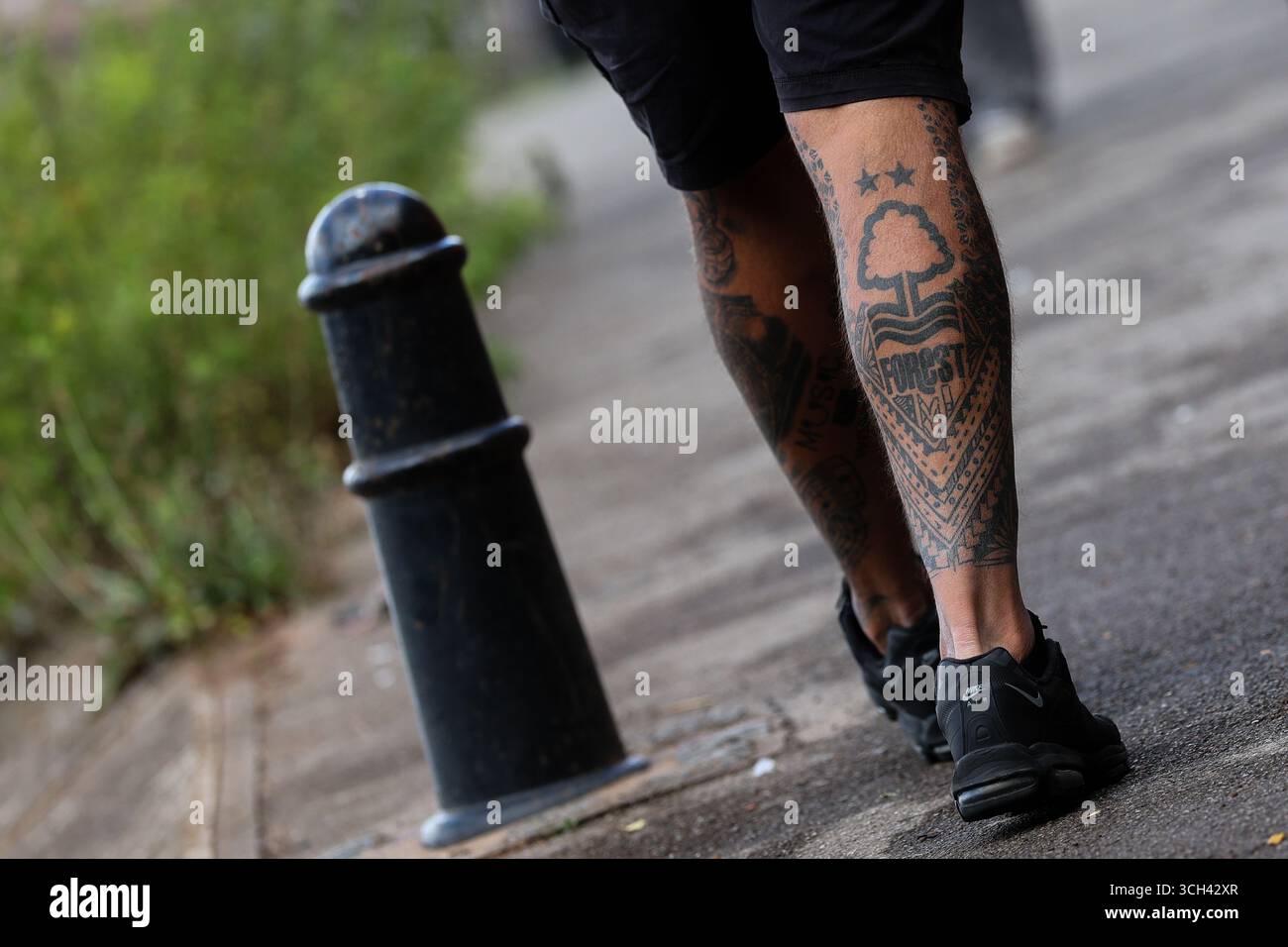 Nottingham, UK. 31st Aug, 2025. A Nottingham Forest tattoo on the leg of a fan making their way to the City Ground ahead of the Nottingham Forest vs West Ham United Premier League match at the City Ground, Nottingham. Picture credit should read: James Baylis/Sportimage Credit: Sportimage Ltd/Alamy Live News Stock Photo
