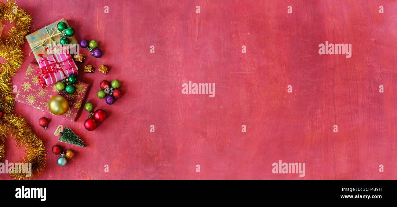 Christmas shopping and christmas present concept with gift wrapped Christmas present boxes and Christmas balls and decoration. Flat lay Stock Photo