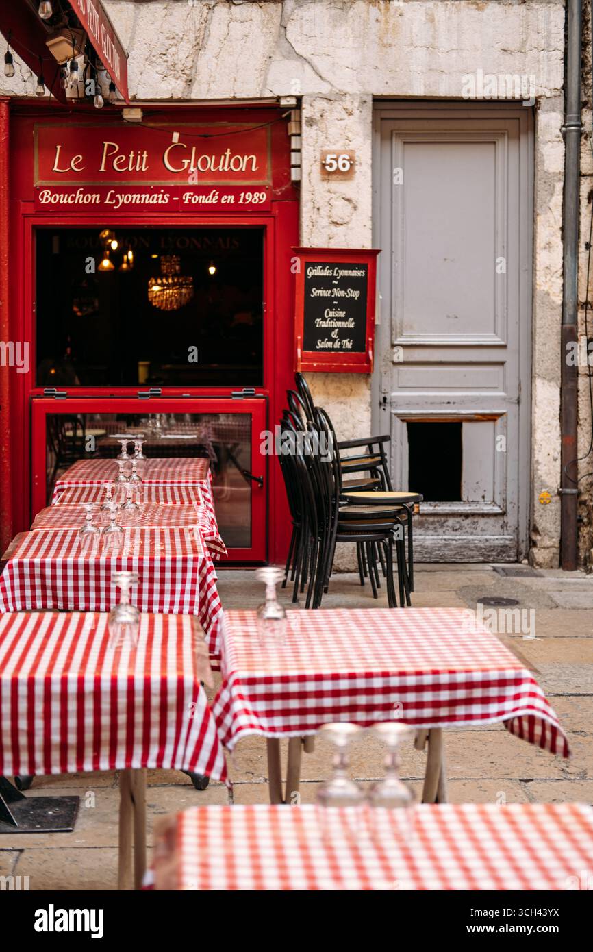 Traditional Bouchon Lyonnais restaurant Le Petit Glouton with red checkered tablecloth terrace in Vieux Lyon UNESCO district, Lyon, France, August 19 Stock Photo