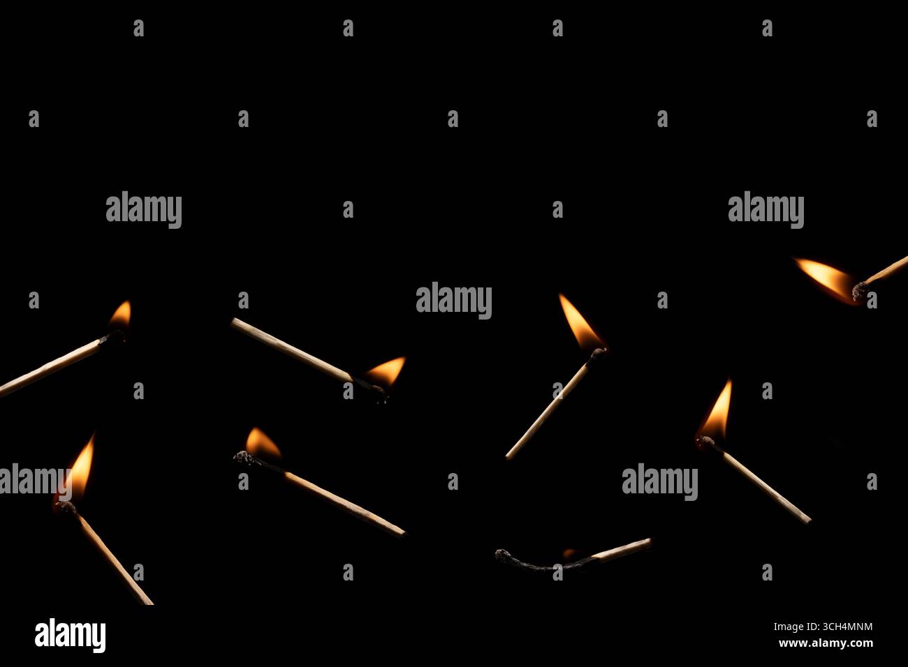 Lit and falling match on a black background. Stock Photo