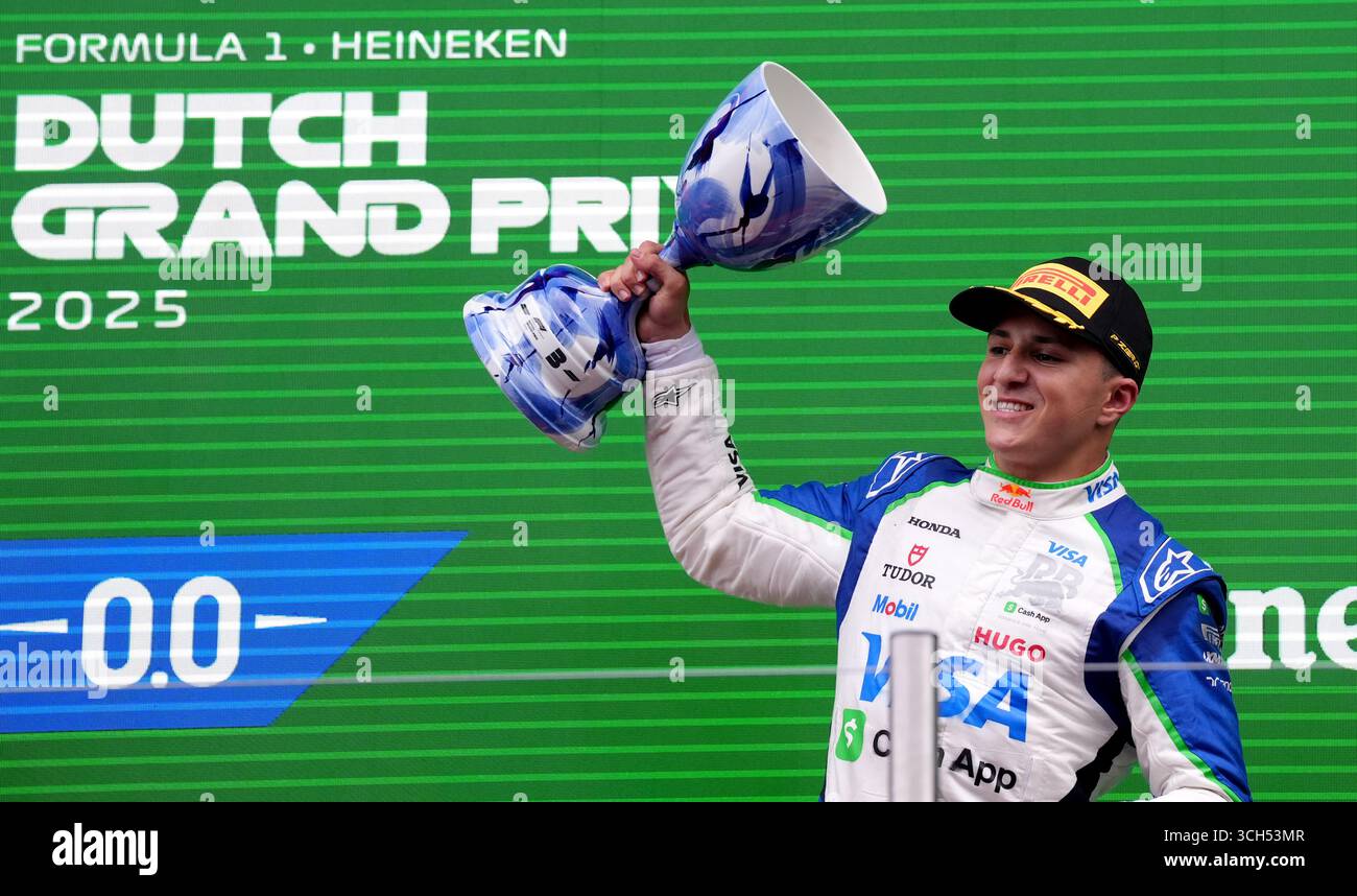Racing Bulls' Isack Hadjar celebrates with the trophy on the podium ...
