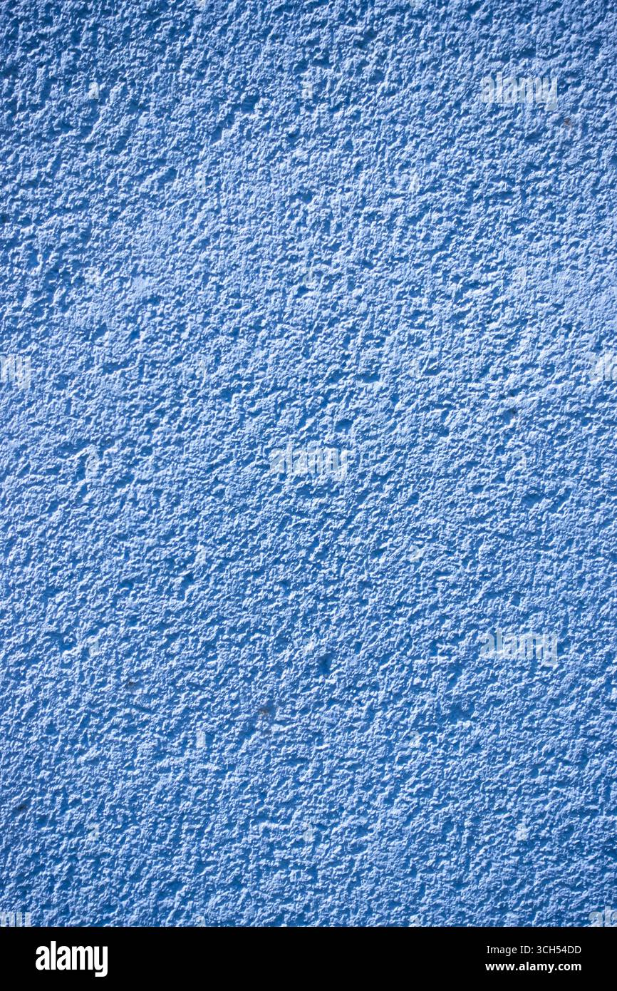 Close up of a blue textured wall surface with rough pattern Stock Photo
