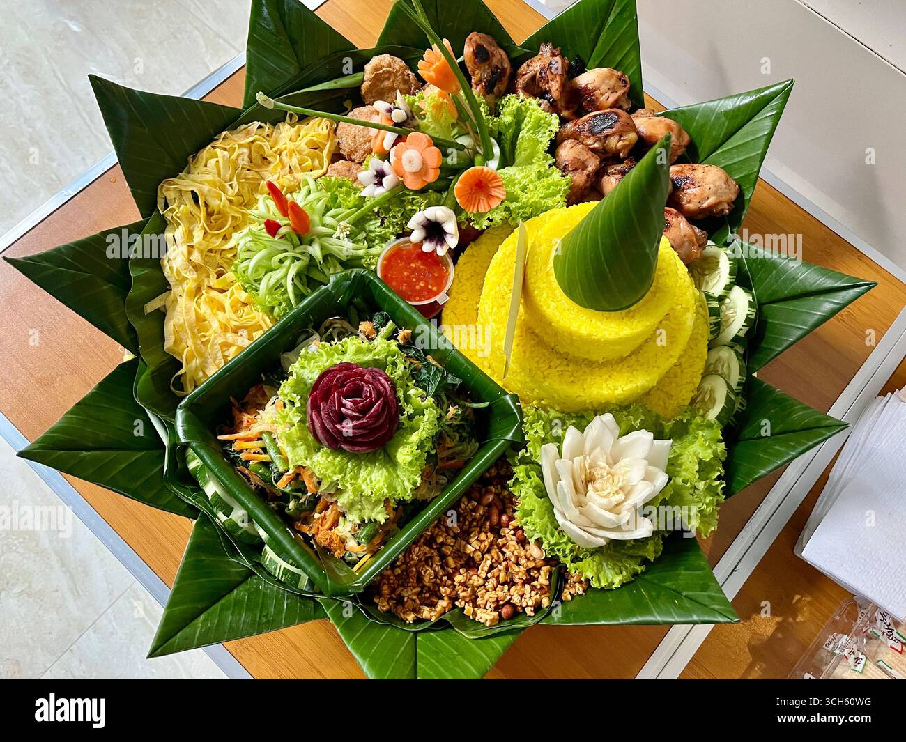 Nasi Tumpeng is a Javanese food in which the rice is served in a cone shape and arranged together with the side dishes - Smartphone Captured Stock Image