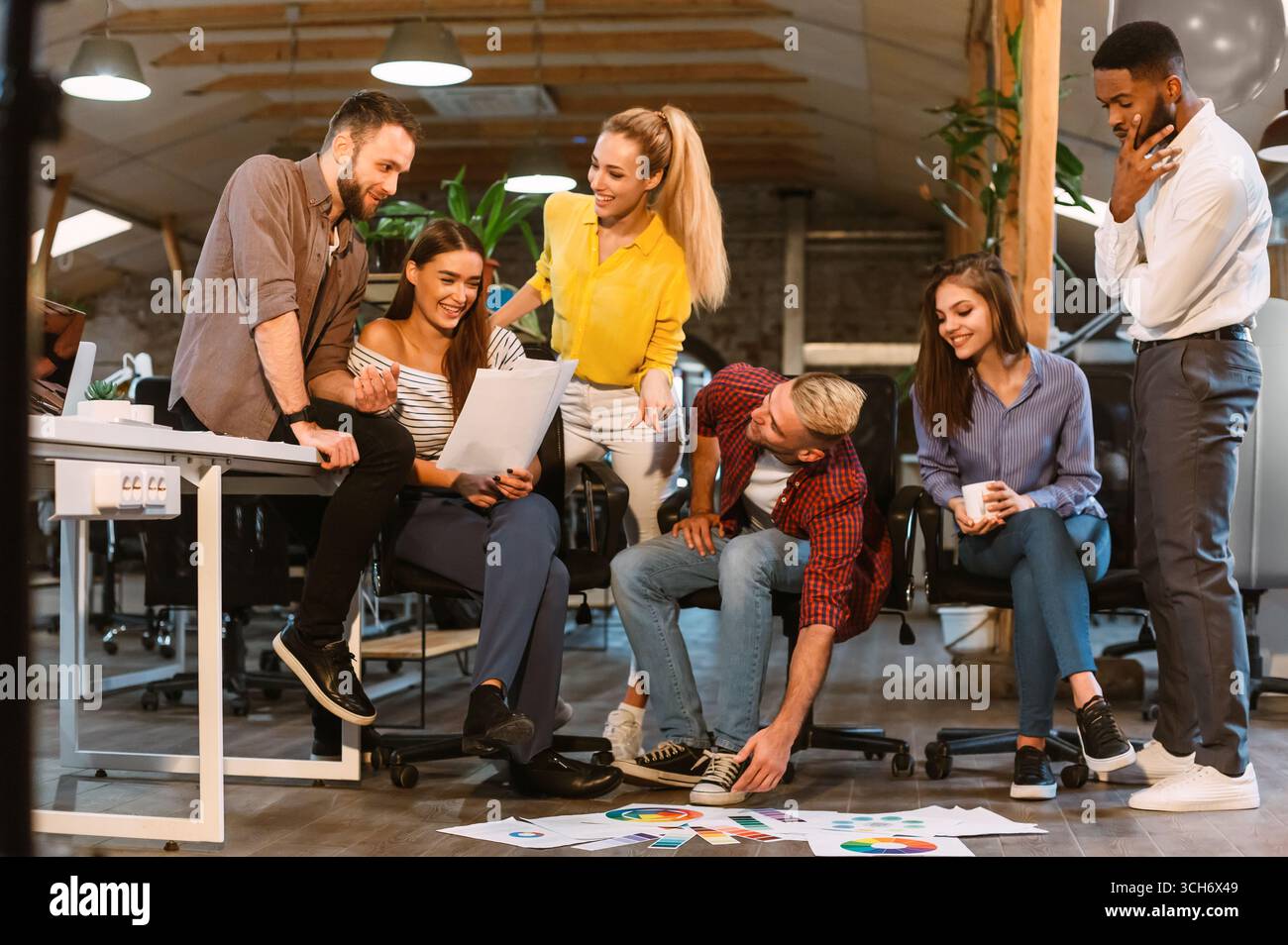Teamwork. Creative colleagues discussing interior designs with palettes Stock Photo