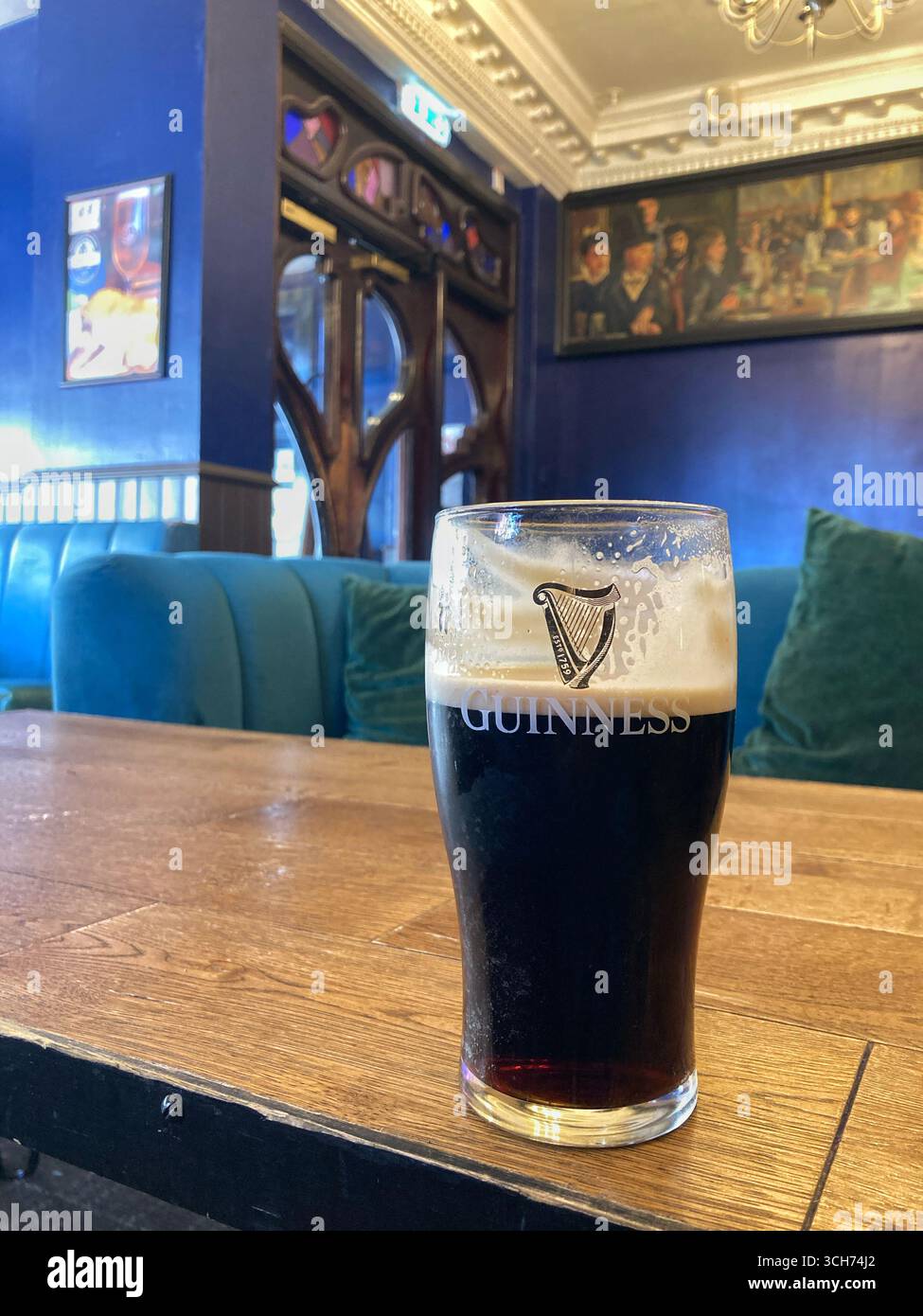 Splitting the G with a Pint of Guinness in a traditional British pub - Smartphone Captured Stock Image