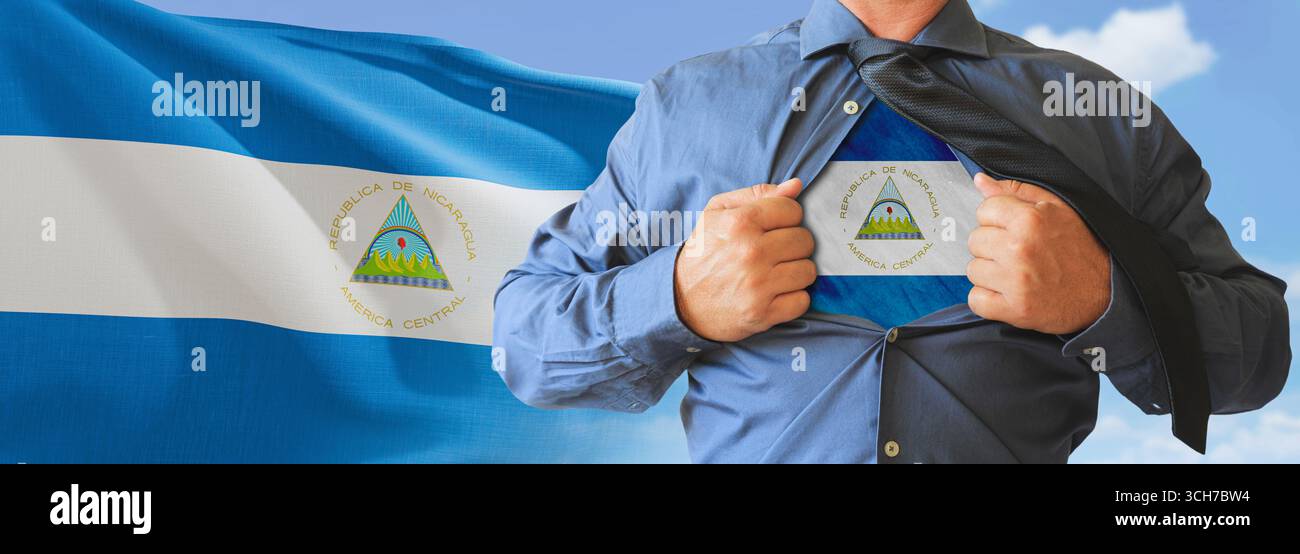 A businessman opening his shirt like super hero with Nicaragua flag and shows how patriotic he is by revealing his countries flag beneath printed on a Stock Photo