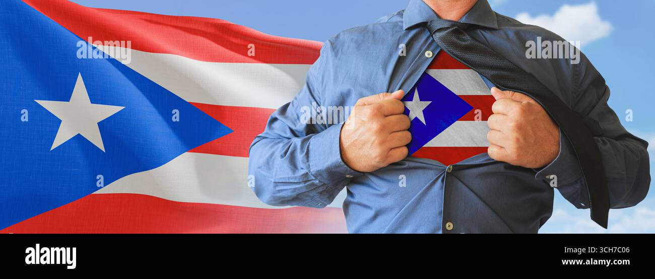 A businessman opening his shirt like super hero with Puerto Rico flag and shows how patriotic he is by revealing his countries flag beneath printed on Stock Photo